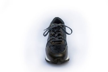 Photograph of black sport shoes on black color withe sequins with white backgroun