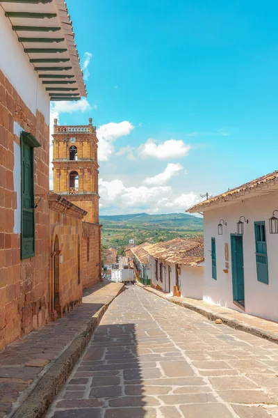 stock image vertical landscape of the colonial streets of barichara santander colombia with the cathedral in the background on a sunny day