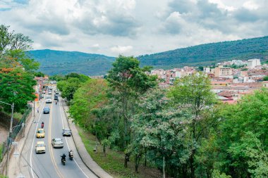 San Gil, Santander, Colombia, April 26, 2024, landscape of Santander Avenue in San Gil with heavy traffic on a sunny day clipart