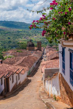 Vertical photo of the colorful streets of Barichara, Santander, Colombia. Its cobblestone streets and colonial houses make this town a paradise to enjoy and explore its history. clipart