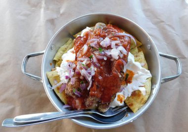 Grilled beef and mutton meat patties with yogurt, pita bread and tomatoes dish, served in a restaurant in Greece