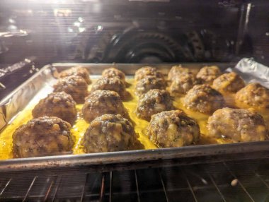 Close-up view of delicious cooked meatballs on baking tray