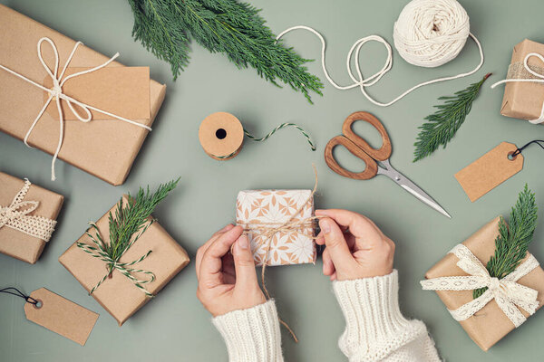 Christmas background with gift boxes and kraft wrapping paper. Xmas celebration, preparation for winter holidays. Festive mockup, top view, flatlay