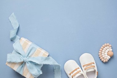 Baby shower, gender reveal, birthday party background with gift box and baby toys. Top view, flatlay, copy space
