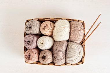 Craft knitting hobby background with yarn in natural colors. Recomforting hobby to reduce stress for cold fall and winter weather. Mock up, copy space, top view clipart