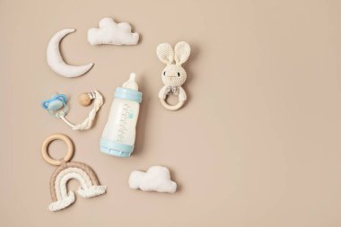 Flat lay with baby sleep accessories with milk bottles, pacifier and toys. Newborn sleeping rules concept