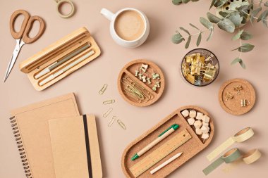 Flatlay of office supplies made of recycled materials on beige background. Flat lay, top view photo mock up.