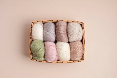 Craft knitting hobby background with yarn in natural colors. Recomforting hobby to reduce stress for cold fall and winter weather. Mock up, copy space, top view