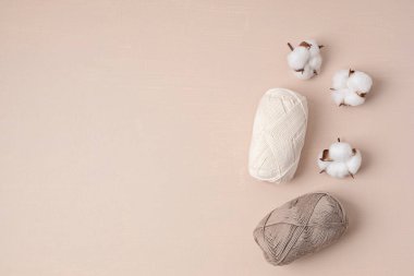 Craft knitting hobby background with yarn in natural colors. Recomforting hobby to reduce stress for cold fall and winter weather. Mock up, copy space, top view