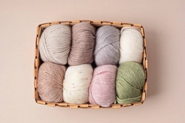 Craft knitting hobby background with yarn in natural colors. Recomforting hobby to reduce stress for cold fall and winter weather. Mock up, copy space, top view