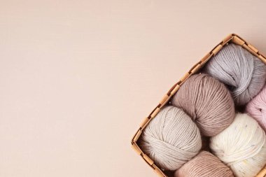 Craft knitting hobby background with yarn in natural colors. Recomforting hobby to reduce stress for cold fall and winter weather. Mock up, copy space, top view