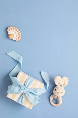 Baby shower, gender reveal, birthday party background with gift box and baby toys. Top view, flatlay, copy space