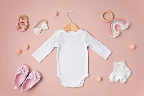 stock image Mockup of white infant bodysuit made of organic cotton with eco friendly baby accessories. Onesie template for brand, logo, advertising. Flat lay, top view