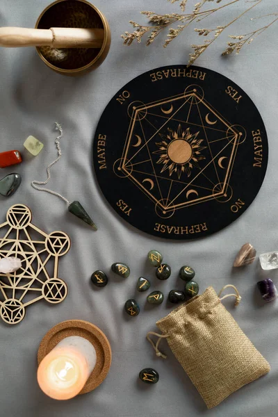 Crystal grid, set of rune stones, pendulum boardfor divination and fortune telling. Mystic still life with labradorite runes. Esoteric, occult , witchcraft rituals idea