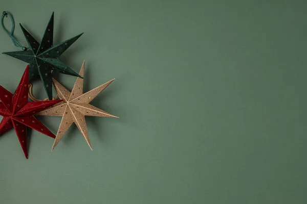 Scandinavian christmas paper stars ornaments in the box. Modern sustainable christmas decoration, minimalist and plastic free. Top view, flat lay