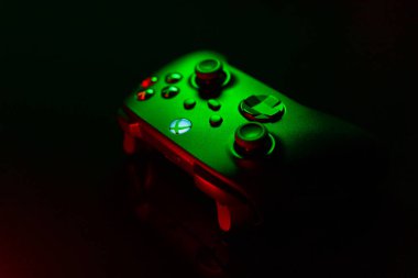 January 9, 2023, Odessa, Ukraine. A black Xbox Wireless Controller highlighted in green and red. Compatible Xbox Series X|S, Xbox One on a dark background.