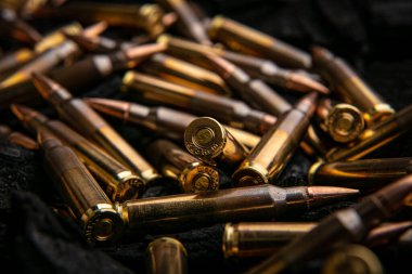 Otomatik karabina kalibresi için fişekler .223 kalibre kömürde. Otomatik ve yarı otomatik tüfekler için mühimmat. Koyu arkaplan.
