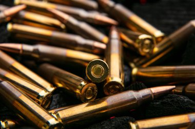 Otomatik karabina kalibresi için fişekler .223 kalibre kömürde. Otomatik ve yarı otomatik tüfekler için mühimmat. Koyu arkaplan.