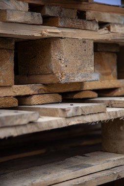 Düşük açılı eski, yıpranmış ahşap paletler üst üste istiflenmiş..