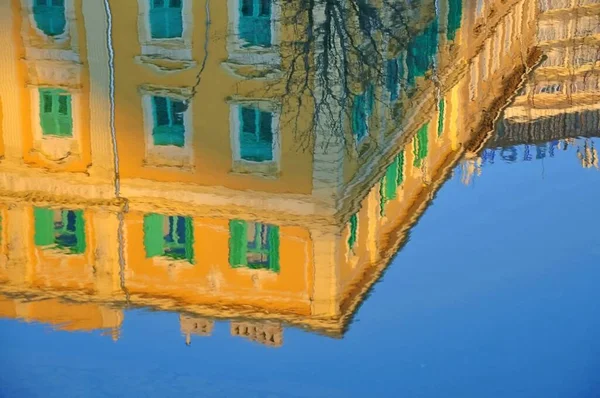 Blurry Reflection of building on Rijeka canal. Rjecina river with city reflections on the calm water, moored boats in the city of Rijeka, Croatia. Reflection of buildings in the Canal of Rijeka city