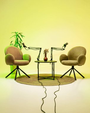 Bu rahat podcast seti esnek kollarda iki pelüş sandalye ve mikrofon barındırıyor. Küçük bir masa bir vazo tutarken, bitkiler doğanın bir dokunuşunu ekleyerek, onu ilgi çekici tartışmalara davet ediyor..