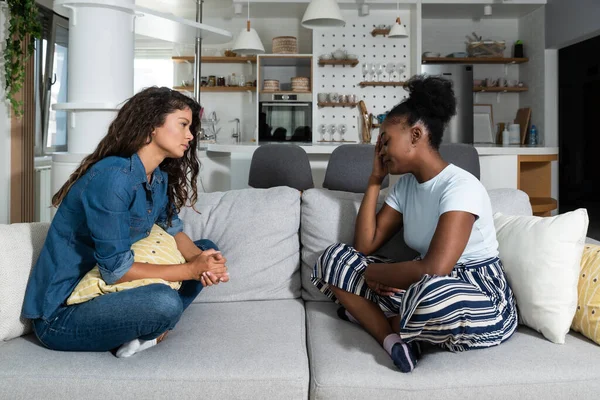 Sad young black woman feeling negative emotions talking to her roommate and friend. Young girl in trouble feeling sadness and depressive. Depressed African American Girl With bad Emotions And Feelings