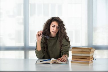Okuması ve sınava çalışması gereken bir yığın kitaptan bıkmış genç bir üniversiteli hukuk öğrencisi. Geleceğin avukat kızı sınavdan önce gergin ve gergin hissediyor. Eğitim kavramı