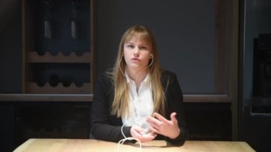 Young woman health care worker psychologist and psychotherapist talking online on web conference video call about how to reduce stress and anxiety in everyday life. Female expert with headphones
