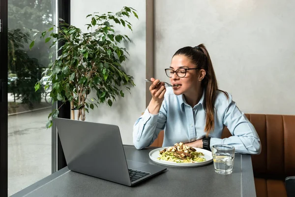 Young successful happy business woman on her lunch break takes the opportunity to have a video call with her boyfriend who works in another company. Online dating and flirting on the internet