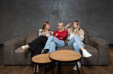 Three young candidates are waiting in the waiting room for a job interview. Group of women sitting and waiting to be called to the employment office