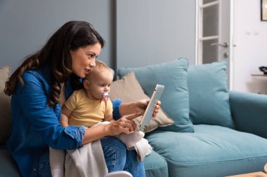 Mother, baby and tablet on sofa watching educational video online on streaming service in home. Love, family time and woman with girl child smile on couch to watch kids movie or cartoon on website.