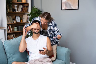Mutlu eş kocasını şaşırtır, gözlerini kapatır ve hamilelik testi yapar. İyi haberleri paylaşacak, yatak odasında birlikte poz verecek baba olacağını bildirir. Neşeli müstakbel ebeveynler