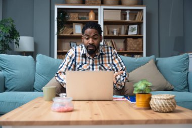 Young black African American man talking on video call with his psychotherapist doctor after online therapy sessions, happy that he is well and mentally health now after telemedicine conversations.