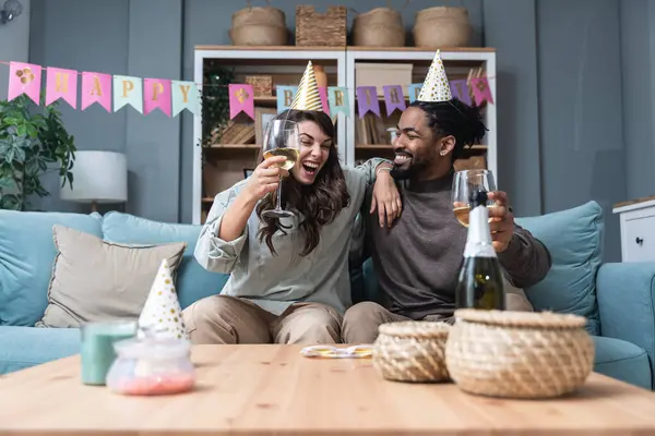 Simple living. Happy young couple celebrate birthday, having party at their new apartment, started to live together. Girlfriend and boyfriend having celebration alone at their new home.