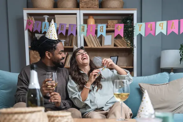 Simple living. Happy young couple celebrate birthday, having party at their new apartment, started to live together. Girlfriend and boyfriend having celebration alone at their new home.