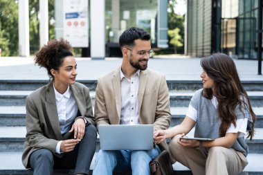 Bir grup genç iş adamı, ofis binasının önünde işverenle görüşmek için çağrılmayı bekleyen iş adayları. İş adamları ve iş kadınları insan kaynaklarını bekliyor.