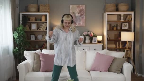 Overjoyed Millennial Girl Wearing Headphones Have Fun Moving Listening Music Stock Video
