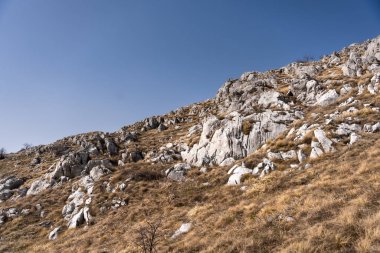 Details of the nature and natural state of the Rtanj mountain in eastern Serbia. Rtanj mountain, also known as the Serbian pyramid with rocks and vegetation. clipart