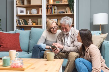 Basit bir yaşam. Kızı, akıllı telefondan aile fotoğraflarına bakıp, anılarını canlandırmak için evdeki üst düzey ebeveynlerini ziyaret etmiş. Yaşlı adam ve kadın, kızları ziyarete geldiği için mutlular..