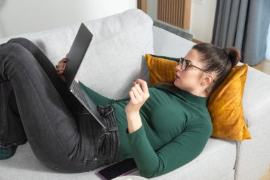 Kariyer sahibi zihniyeti. Evde çalışan serbest çalışan genç bir iş kadını. İş hayatında daha iyi fırsatlar elde etmek için kendine güvenen ve kendini eğiten, dizüstü bilgisayarda çalışan bir kadın..