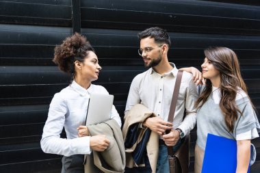 Kariyer sahibi zihniyeti. Bir grup genç iş adamı ofis binasının önünde. İşadamı ve kadınların kendilerini iş hayatında daha iyi fırsatlar için eğittiklerinden emin..
