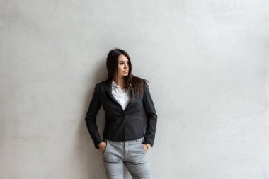 Ofis binasında duran kendine güvenen bir iş kadınının resmi portresi. Şirin bayan iş adamı pozu.