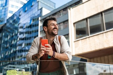 Young independent hipster businessman freelance motivational speaker life coach standing in front of office building preparing for staff meeting. Businessperson product strategy expert waiting clipart