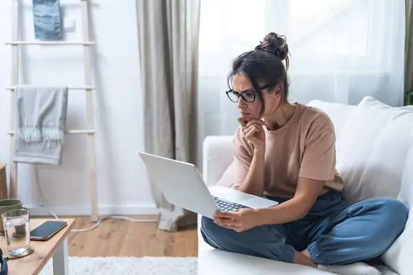 stock image Young unemployed jobless woman sitting at home hoping for easy money and quick cash earnings from internet, work online for passive income paid surveys website surfing click for cash affiliate program