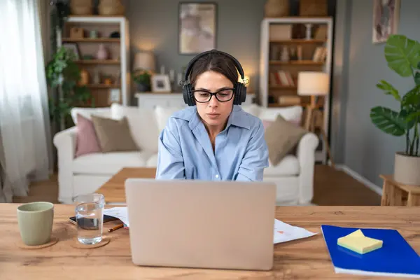 stock image Pensive young businesswoman look laptop screen work online home office think of problem solution Thoughtful millennial business female unmotivated for computer job Laziness concept lack of motivation.