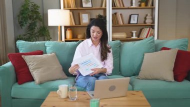 Genç iş kadını serbest yurtdışında çalışan finansal ve dijital pazarlama uzmanı evde çalışıyor ve dizüstü bilgisayarlı web kamerasında video görüşmesi yapıyor. İnternet fırsatları küresel iş