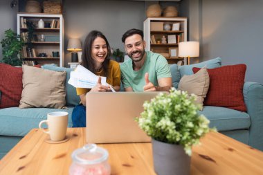 Successful young business people working together in home office. Freelance couple teamwork businessman and businesswoman startup concept video call presentation on laptop computer and webcam