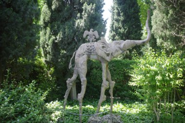 Girona, Spain - 26 May, 2024: Salvador Dali's statue of an Elephant in the gardens of the Gala Dali Castle in Pubol, Catalonia clipart