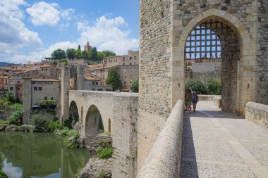 Girona, Spain - 7 July, 2024: The medieval Pont Vell bridge crossing the River Fluvia at Besalu, Catalonia clipart