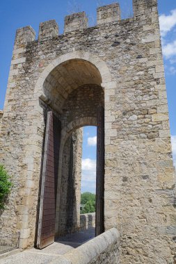 Girona, Spain - 7 July, 2024: Gate tower at the entrance to Pont Vell, in the medieval village of Besalu, Catalonia clipart